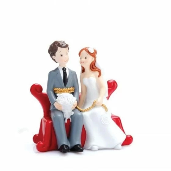 Un couple de mariés sur un sofa rouge