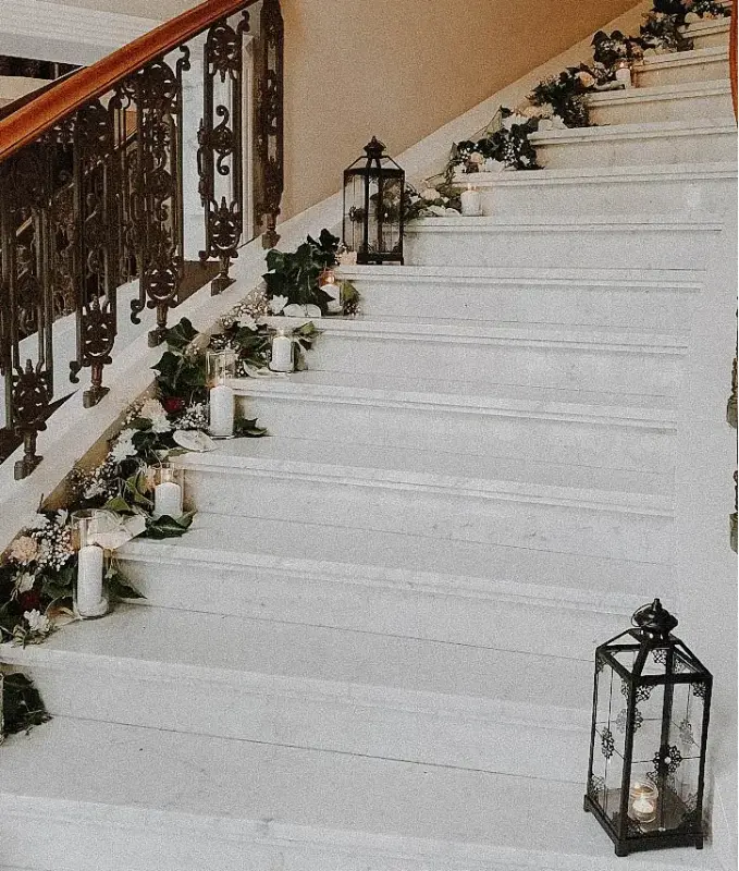 Escalier décoré de bougies et de verdure – Petit Versailles, mariage de M et T, juillet 2022